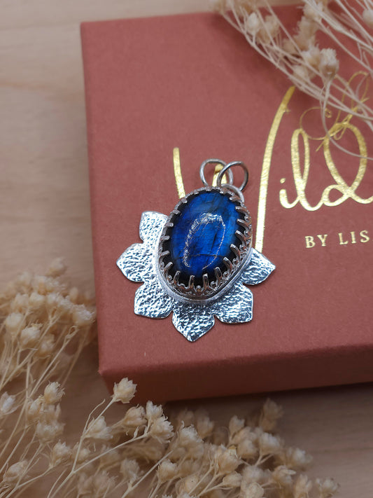 A sterling silver hammered flower necklace with a blue Labradorite gemstone.