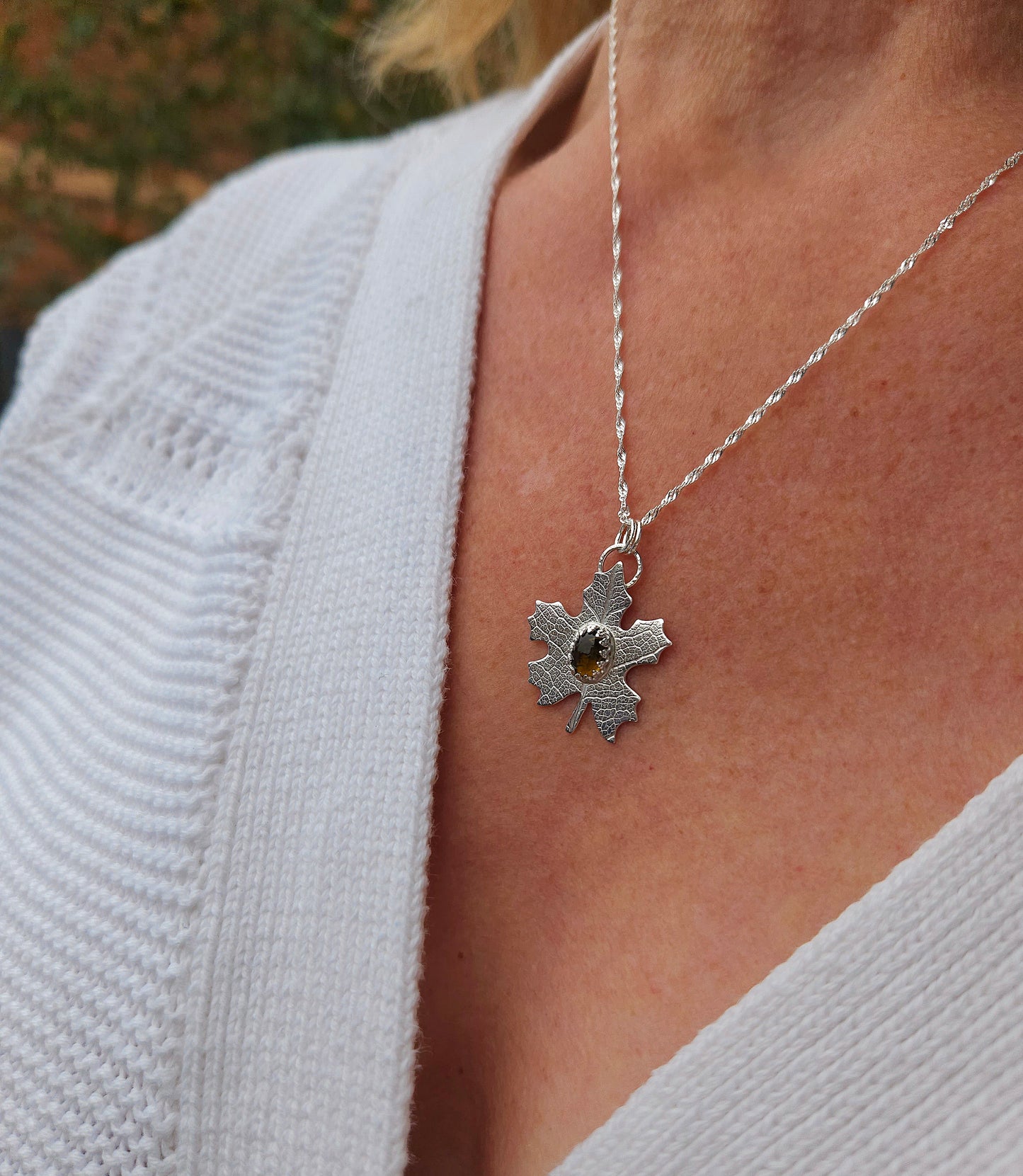 A model wearing the brown tourmaline leaf pendant in silver.