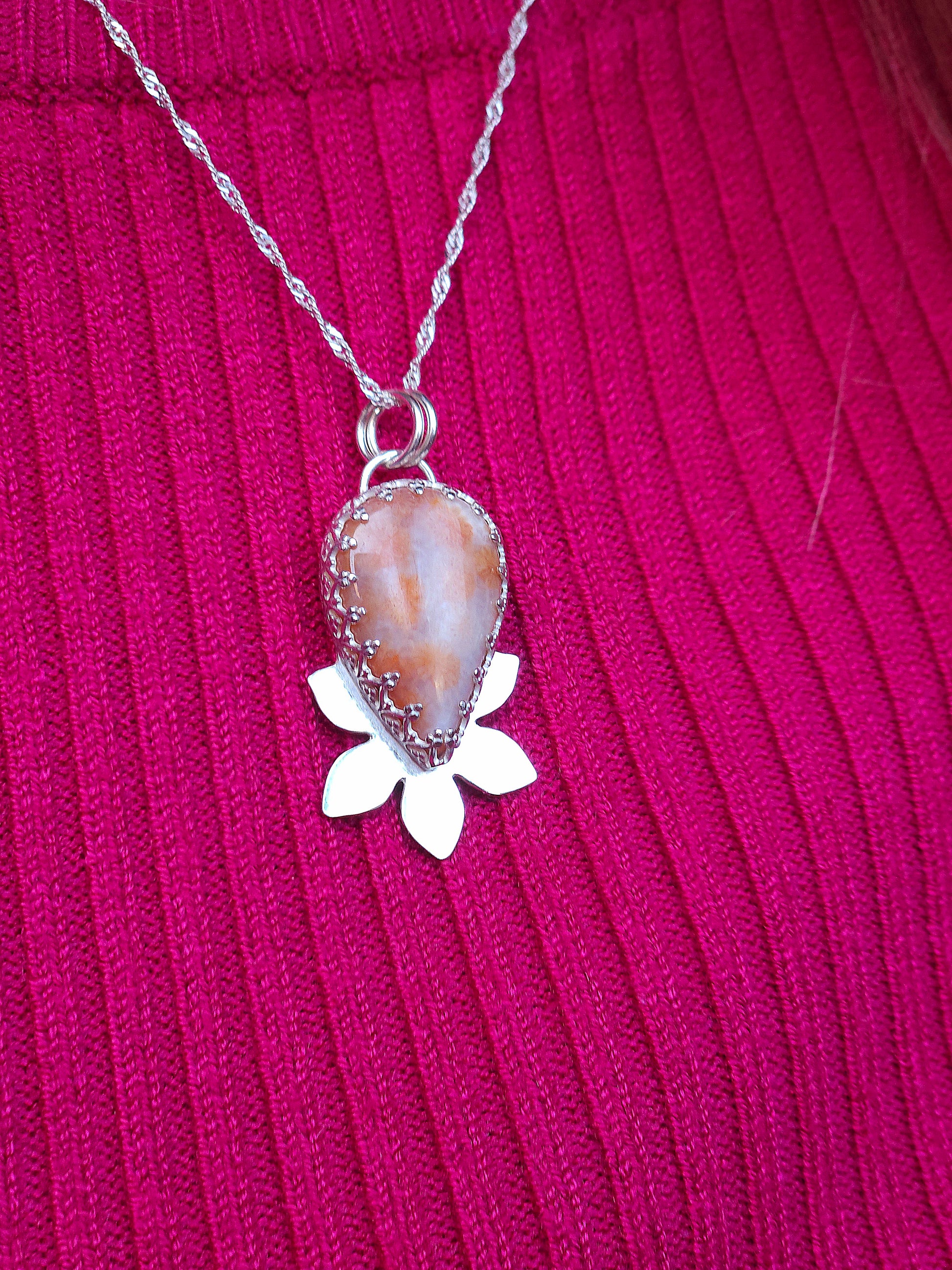 The pink fossil coral flower necklace being worn.