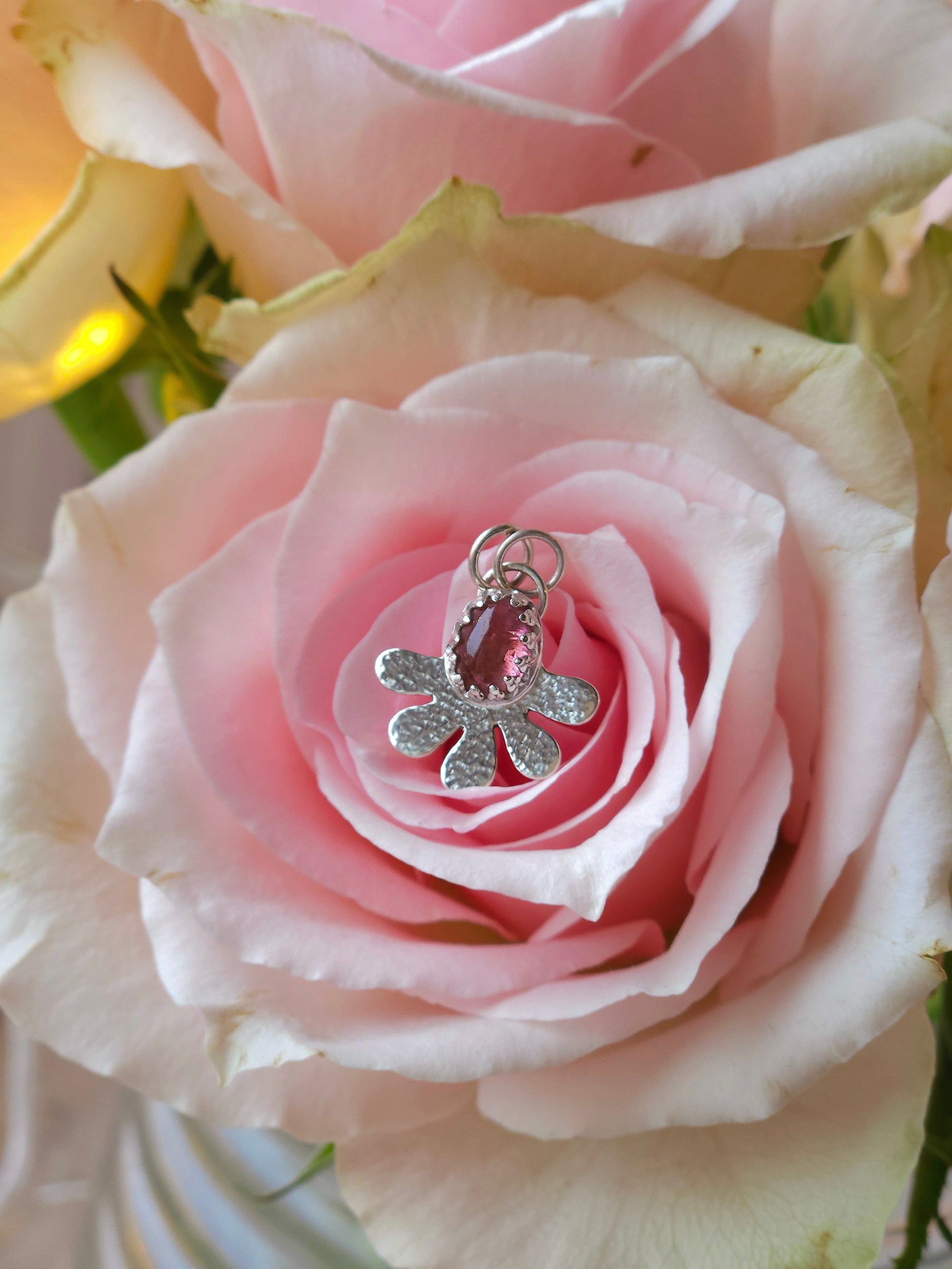 A dainty hammered flower necklace with a Pink Tourmaline gemstone.