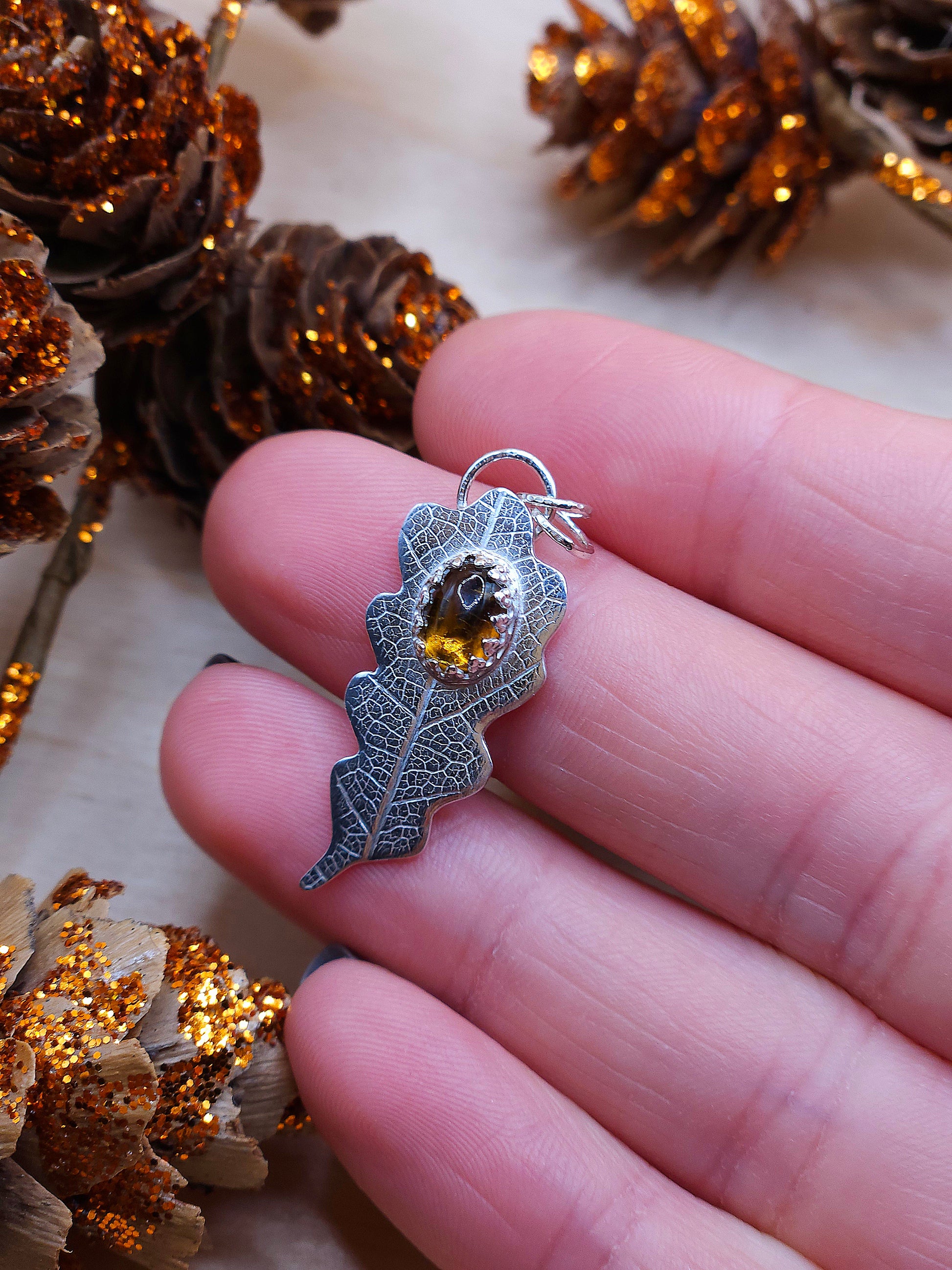A sterling silver leaf print necklace with a brown Tourmaline gemstone.