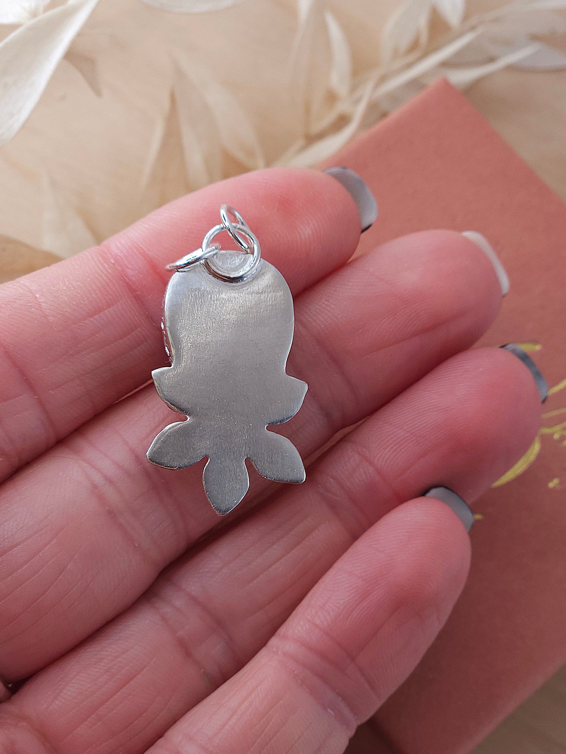 A back view of the silver fossil coral flower necklace.