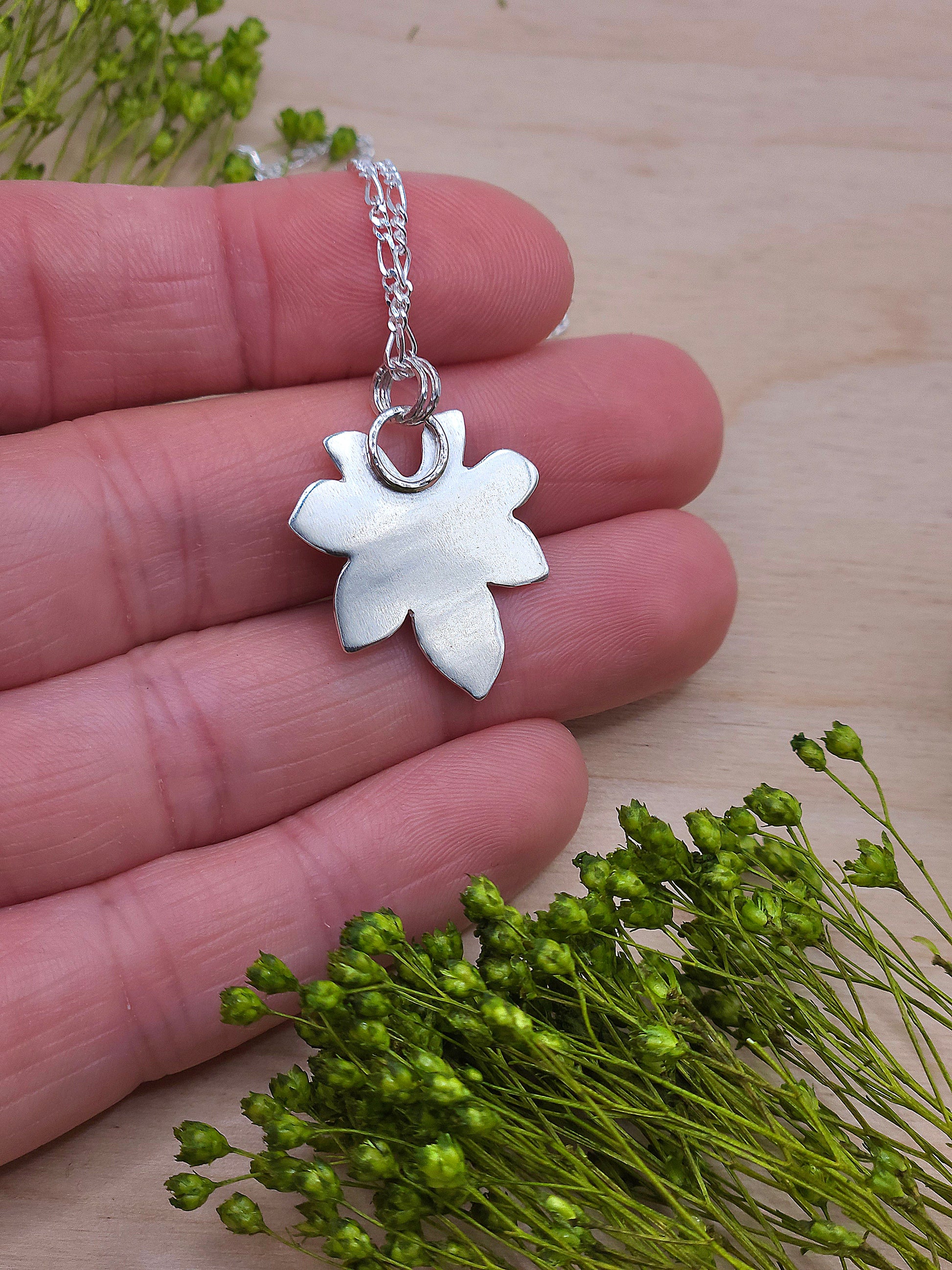 A back view of the silver leaf pendant.