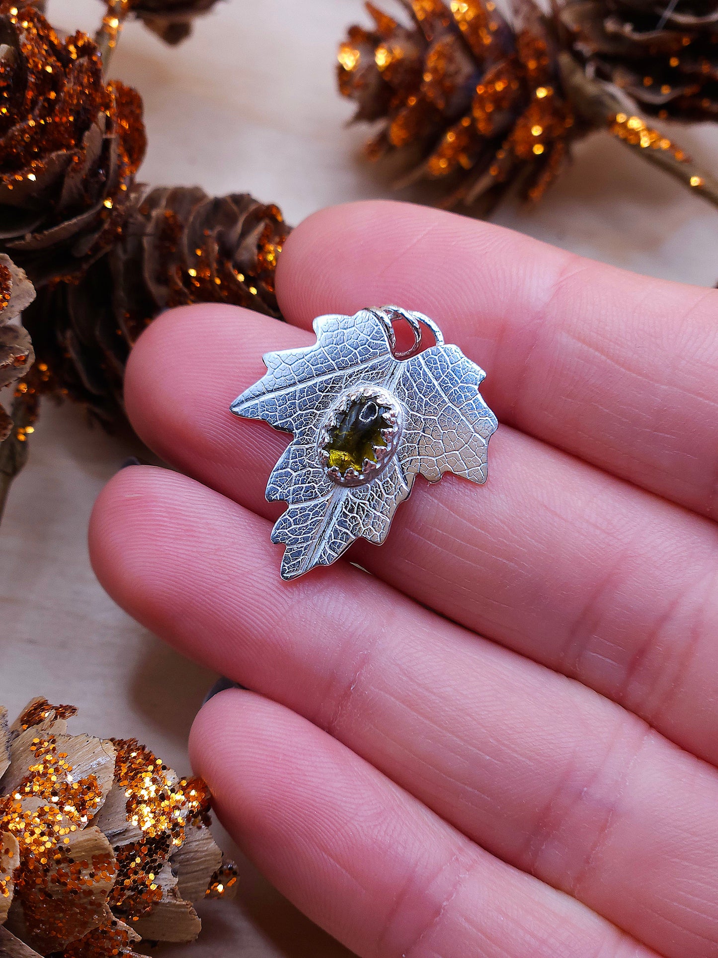 A brown tourmaline leaf pendant with a real leaf texture.