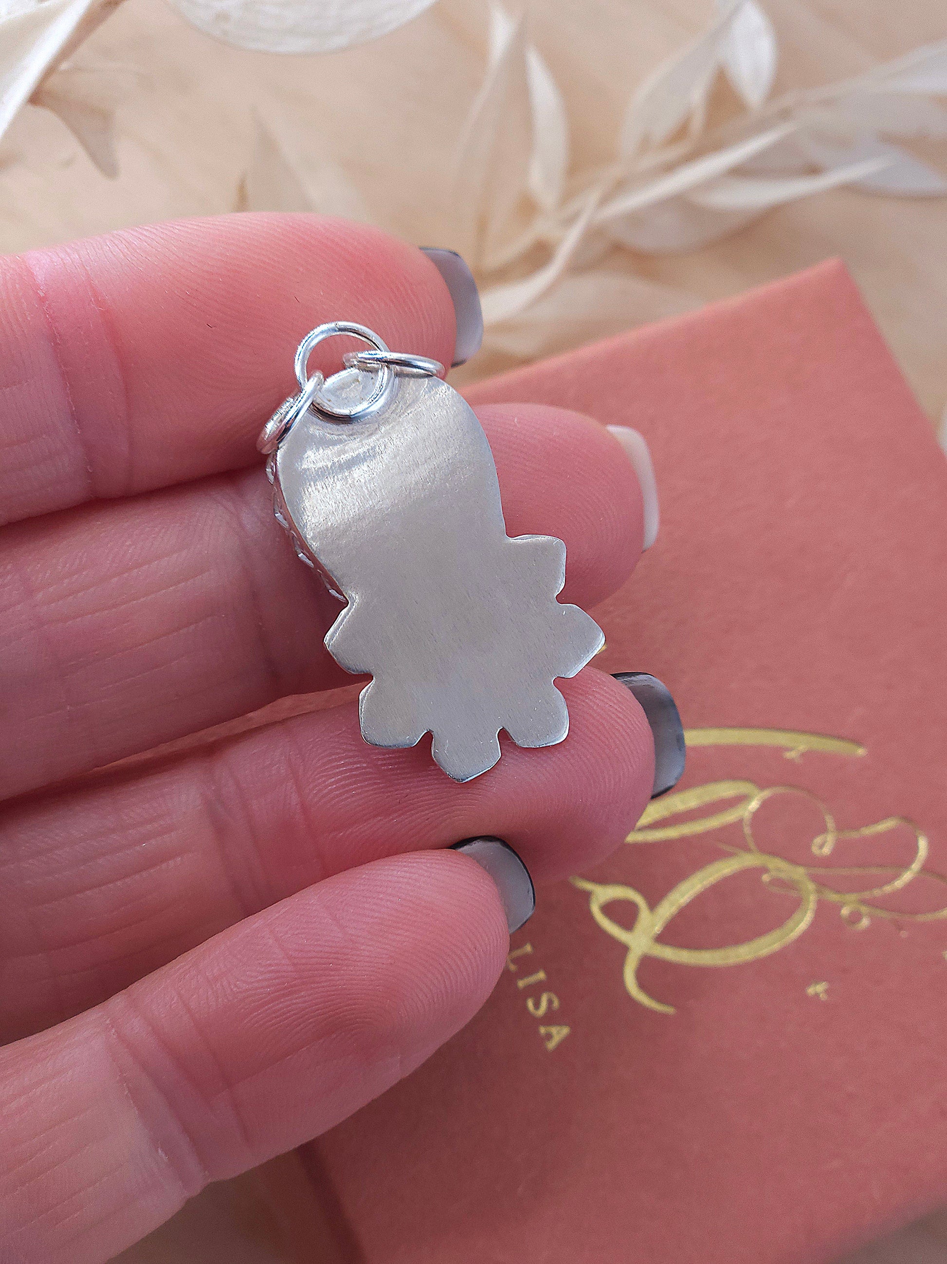 The back view of the silver fossil coral flower pendant.