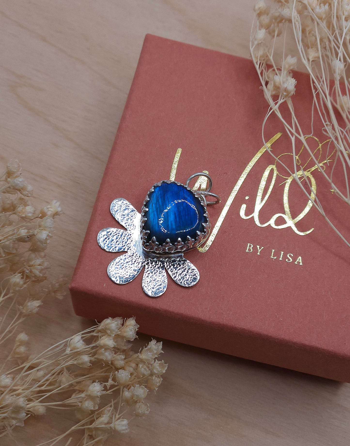A view looking down on the blue Labradorite hammered flower pendant.