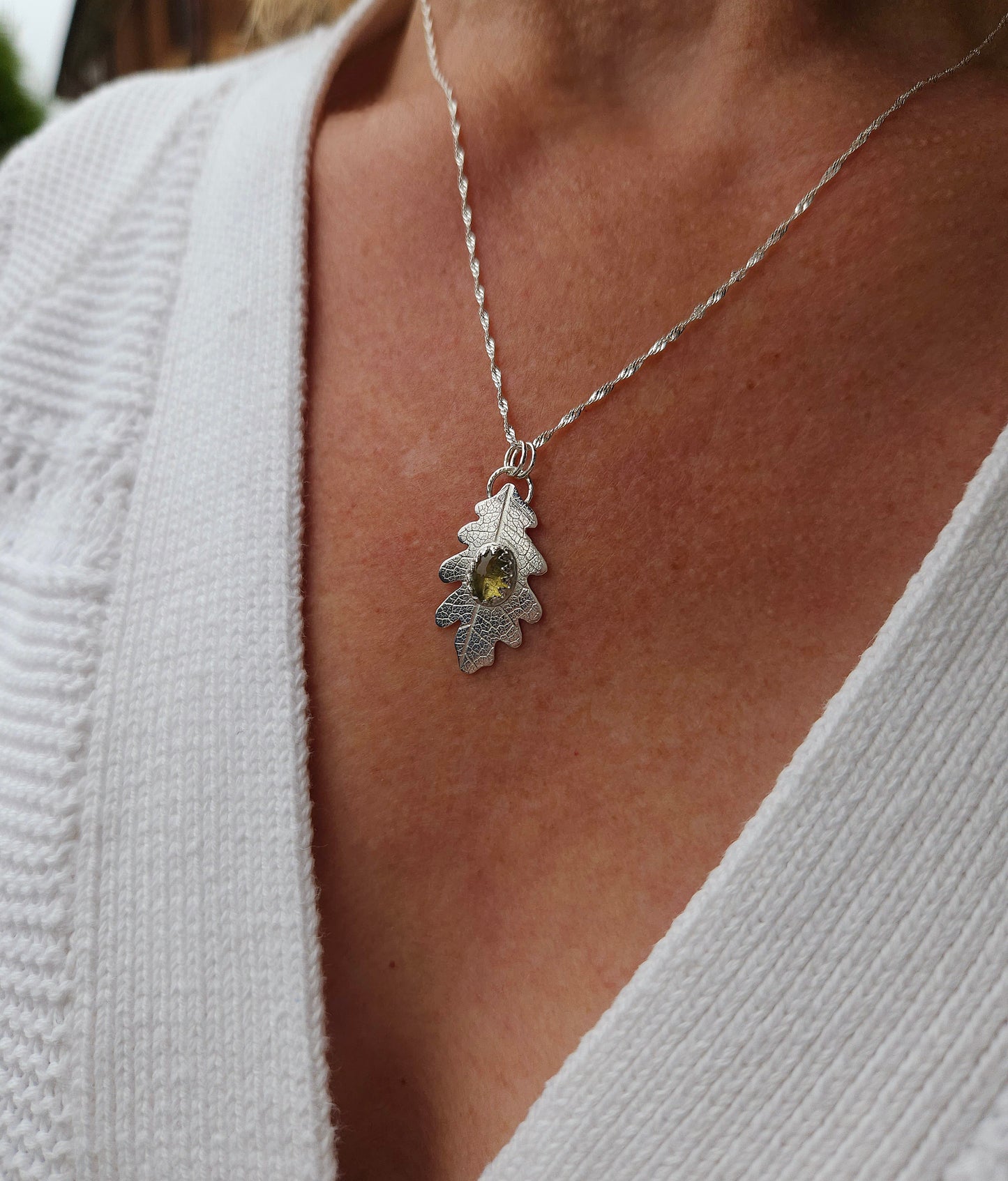 A model wearing the neutral tourmaline leaf necklace.