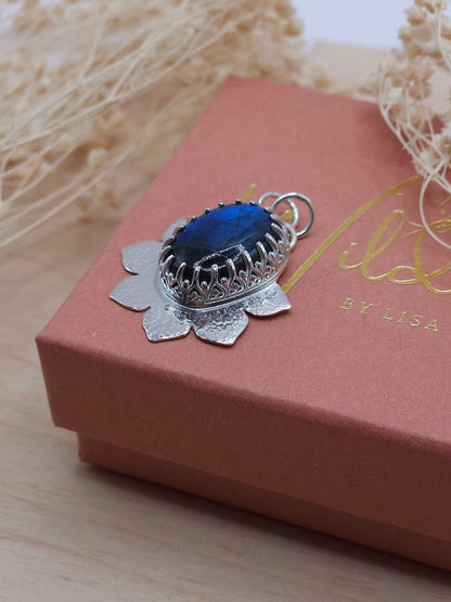 A silver hammered flower necklace with blue Labradorite gemstone.