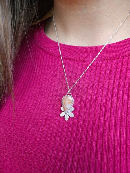 An image showing the pink fossil coral necklace being worn with the 18 inch twisted curb chain.
