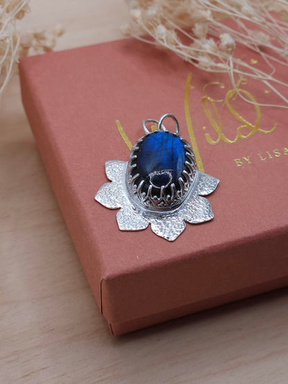 A handmade sterling silver flower necklace with a blue Labradorite gemstone.