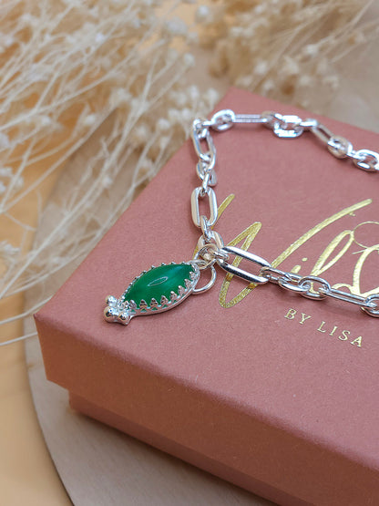 A silver link chain bracelet with a green Aventurine gemstone charm, displayed on a gift box with the brand name 'Wild by Lisa'.